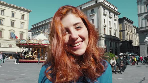 Young Beautiful Girl with Red Hair in Florence Smiles Cheerfully