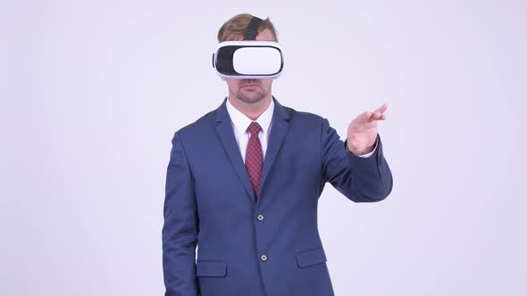 Blonde Businessman Using Virtual Reality Headset