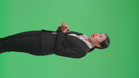 Side View Of Asian Businesswoman Standing And Presenting Something On The Green Screen