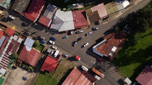 Aerial view from vertically above a busy intersection in Los Angeles de la Fortuna, Costa Rica. Dron
