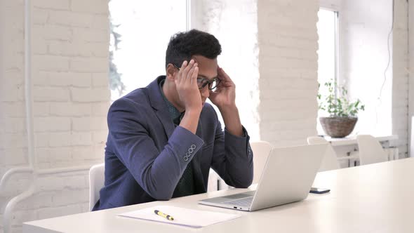 Headache, Stressed Businessman Working on Laptop