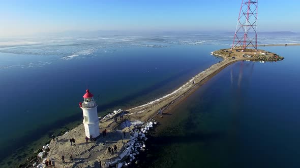 Lighthouse on Tokarev Cat on the Background of the Sea Landscape.