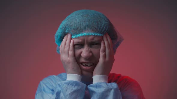 Portrait of Bruised Woman in Medical Clothes with Beatings on Her Face and Teeth in Hospital Looking