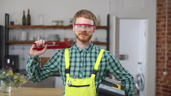 Portrait of Repairman Worker Wearing Protective Glasses Smiling at Camera