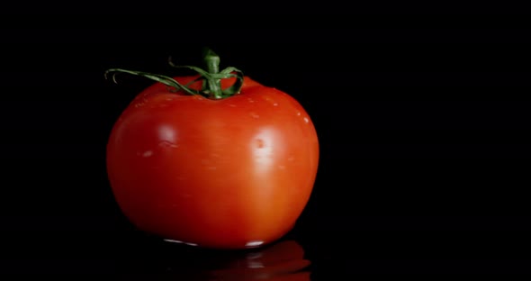 One Tomato Spinning on the Table. 