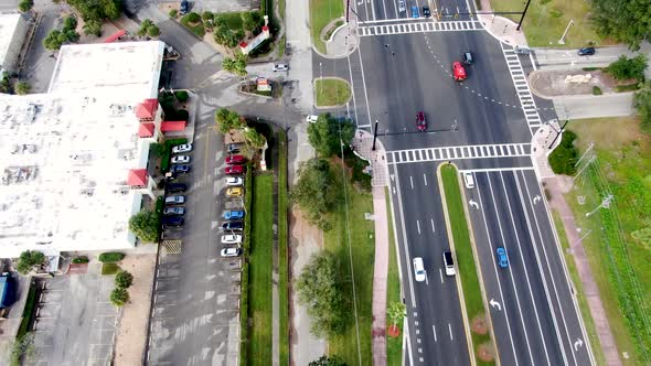 Aerial birdseye flying forward over highway revealing Kissimmee city, Florida