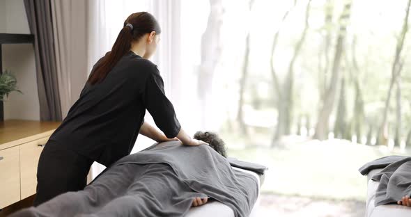 Female Masseur Doing Massage to Male Client