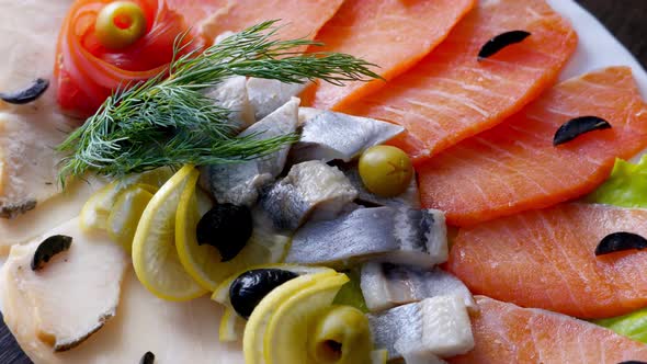 Seafood on Plate  Salmon Herring Fish and Sliced Fish Fillet Rotating