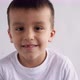 Boy Closeup Brown Eyes Look at the Camera Fooling Around Smiling Emotionally on White Background 4 - VideoHive Item for Sale