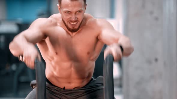 An Attractive Man Bodybuilder Battling Ropes