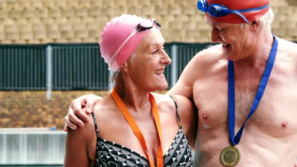 Excited senior couple showing medal