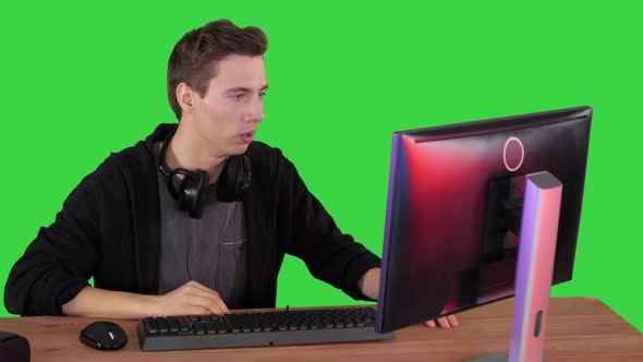 Nervous Man Watching Video Games on a PC Computer on a Green Screen, Chroma Key