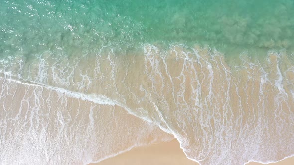 Aerial Top View White Wave Swept On The White Sand Beach.