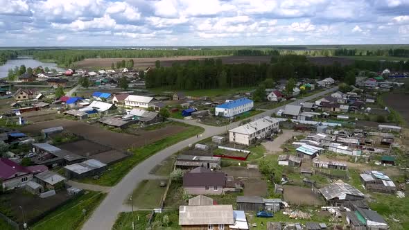 Village with Coloured House Roofs Against Green Forest