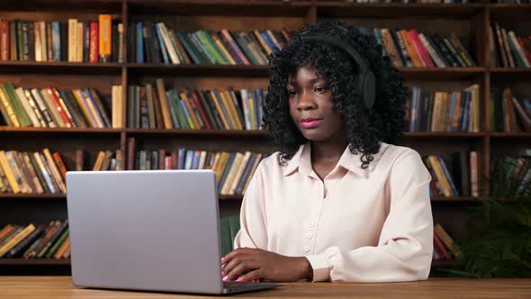 AfricanAmerican Woman Has Videocall From Home Library