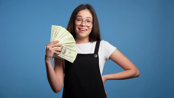 Satisfied Happy Excited Asian Girl Showing Money - U.S. Currency Dollars Banknotes 