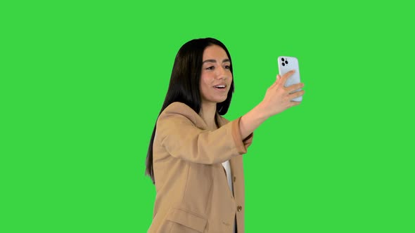 Young Indian Girl Walking and Making a Video Call on a Green Screen Chroma Key