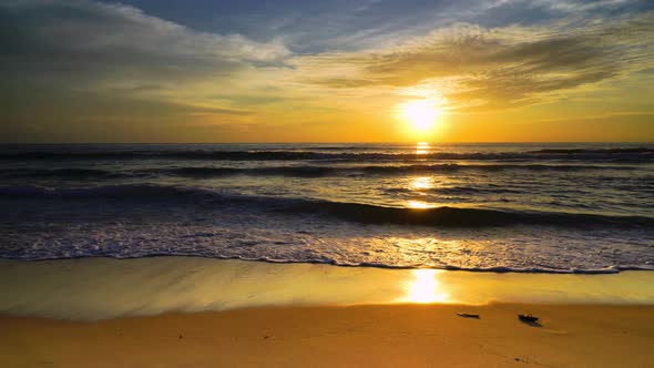 Beach sunset over the ocean and sunlight hits water