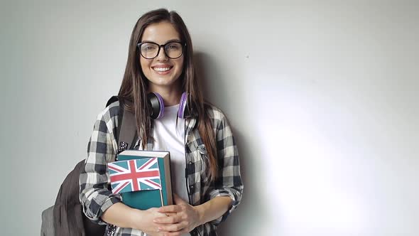 Girl Holding Bag and Books with Great Britain's Flag