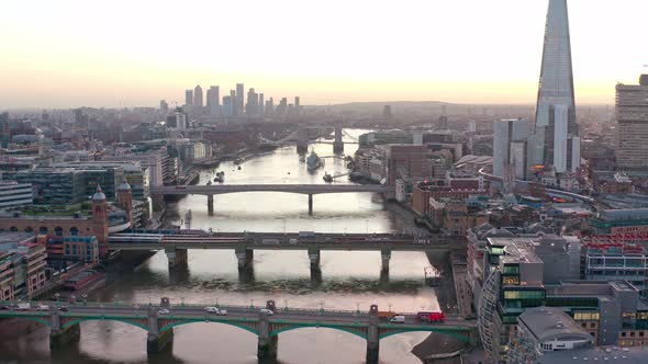Slider truck aerial of bridges over Thames river central London at sunrise