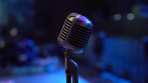 Concert Vintage Microphone on Stage in Club. Close Up Shot of Nice and Shiny Grey Microphone.