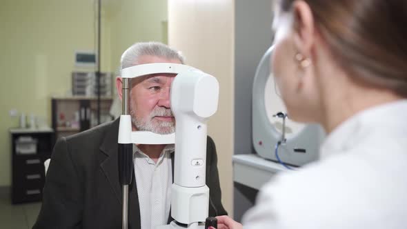 Ophthalmologist Examination of Elderly Man on Corneo Topographer