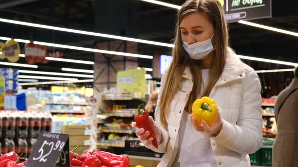 Young Blonde Buys Vegetables at the Local Market