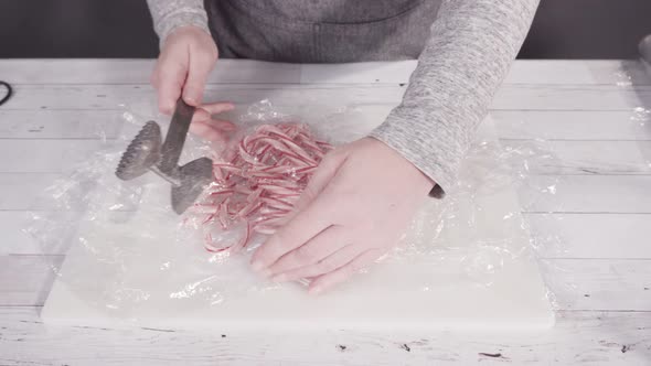 Step by step. Breaking candy cane candies into small pieces