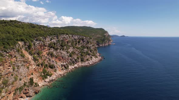 Aerial view of the Pasjaca cliff and beach, blue sea and mountains, Croatia