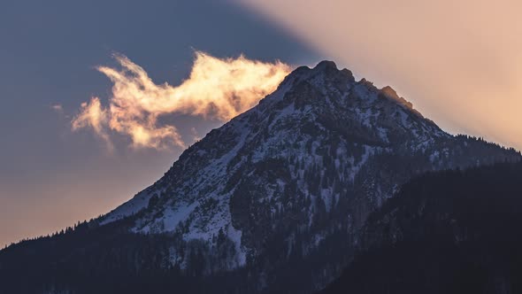 Fast Clouds Motion over Misty Alps Mountain Peak in Sunny Winter Evening Nature