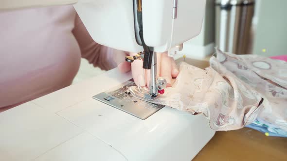 Sewing cotton face mask with a sewing machine for coronavirus outbreak.