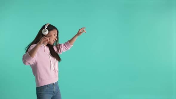 Happy Asian Woman Listening to Music in Headphones