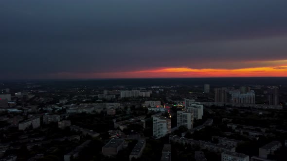 Aerial right to left city view with dramatic sky