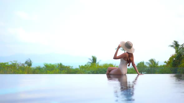 Young asian woman enjoy around outdoor swimming pool for leisure