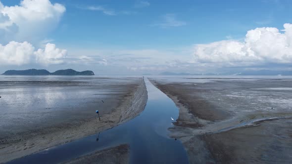 Aerial move over the narrow river muddy land