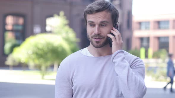 Handsome Man Discussing on Phone