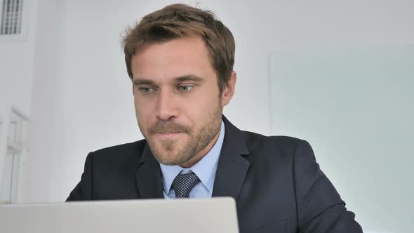 Close Up of Businessman Celebrating Success at Work