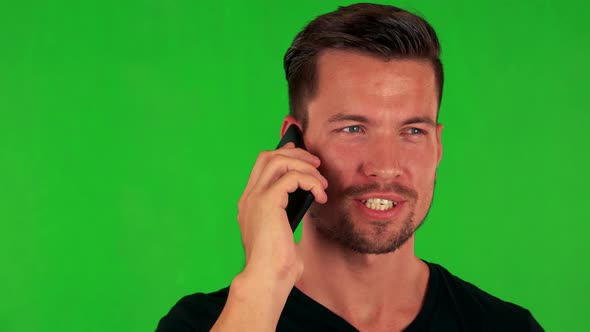 Young Handsome Caucasian Man Phones with Smartphone - Green Screen - Closeup