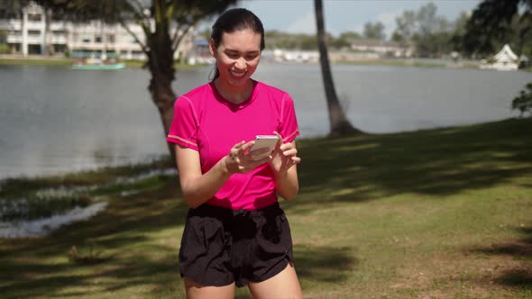 Sportive Woman Reading Funny Message on Smartphone