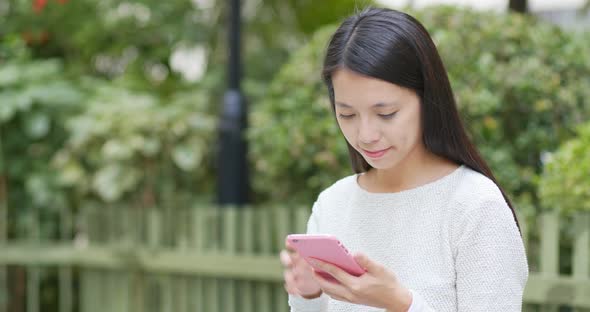 Woman use of mobile phone at park