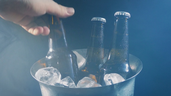 Beer Bottle Is Picked Up Ice Bucket In Vapor