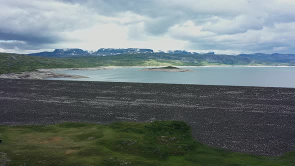 Aerial overview showing massive Sysen-dam Hardangervidda Norway and water level inside - Low water l