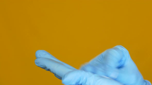 Close-up of a medic disinfects gloves before work