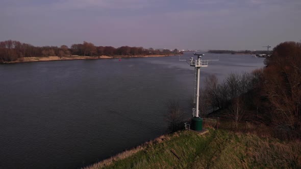 Aerial view of a rotating radar tower on the river