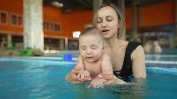 Mother Teaches Her Baby to Swim in a Closed Public Pool