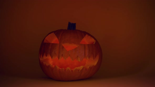 Carved Halloween Pumpkin Flickers in Dark Closeup Pumpkin Jack Face Holiday
