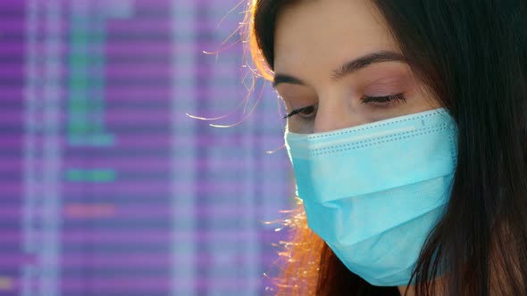 Portrait of Woman Wearing Medical Mask, on Departure Flight Timetable Board Background, at Airport