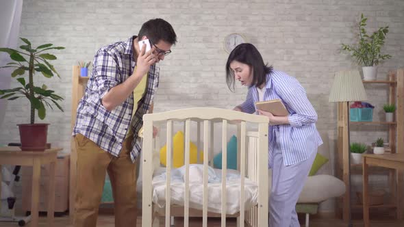 Worried Young Parent in the Nursery Newborn's Bed