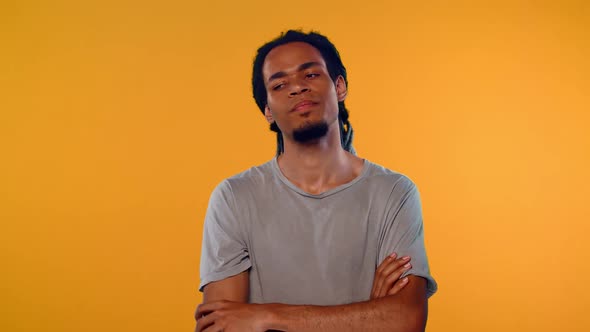 Angry Young African Man Shows Stop Gesture, Crossed Hands Over Orange Background