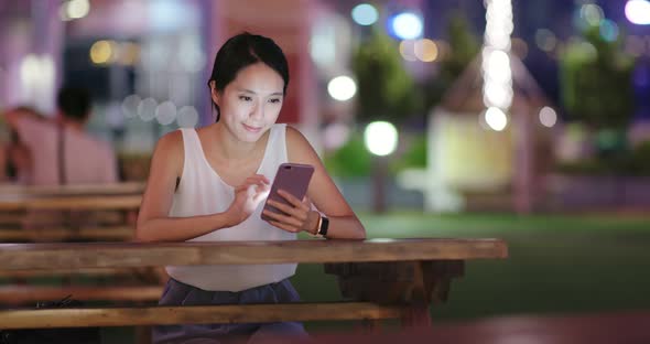 Woman use of mobile phone at outdoor cafe